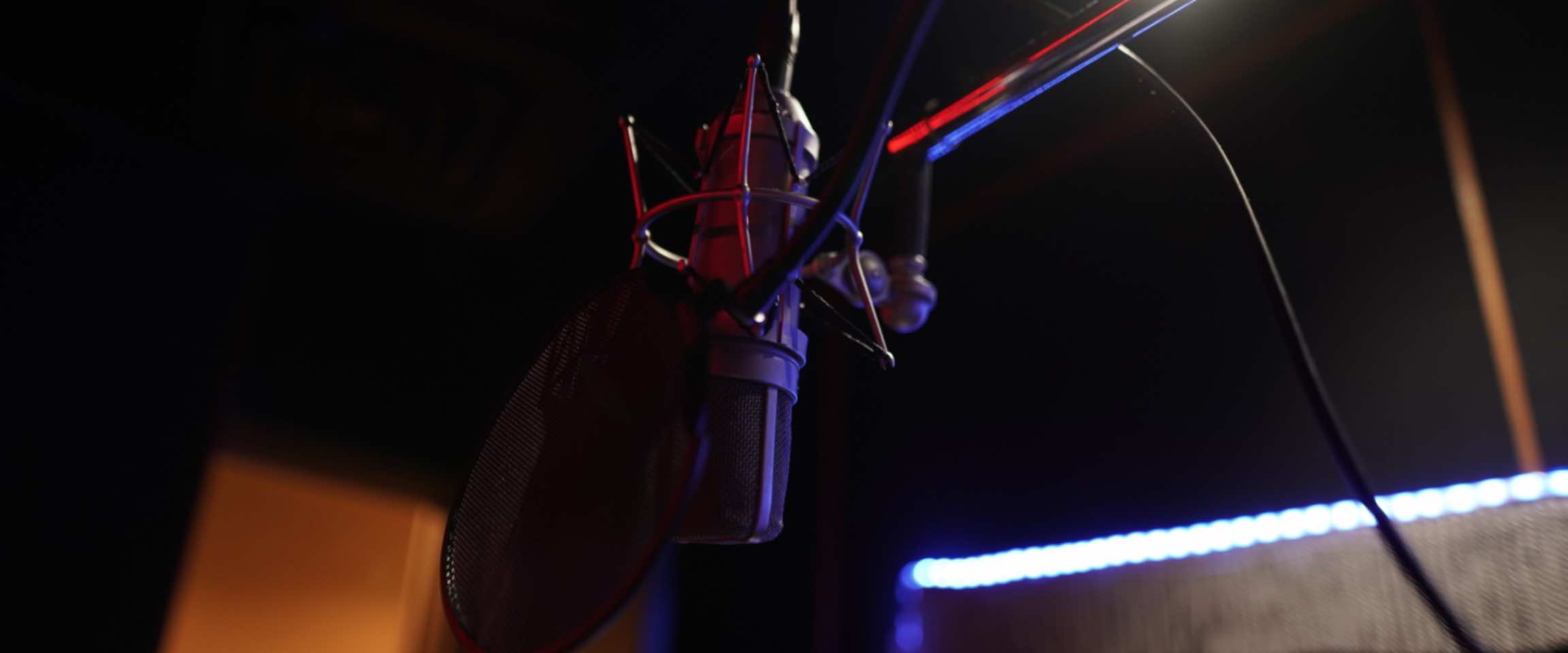 Studio vocal booth with microphone and screen for ADR work